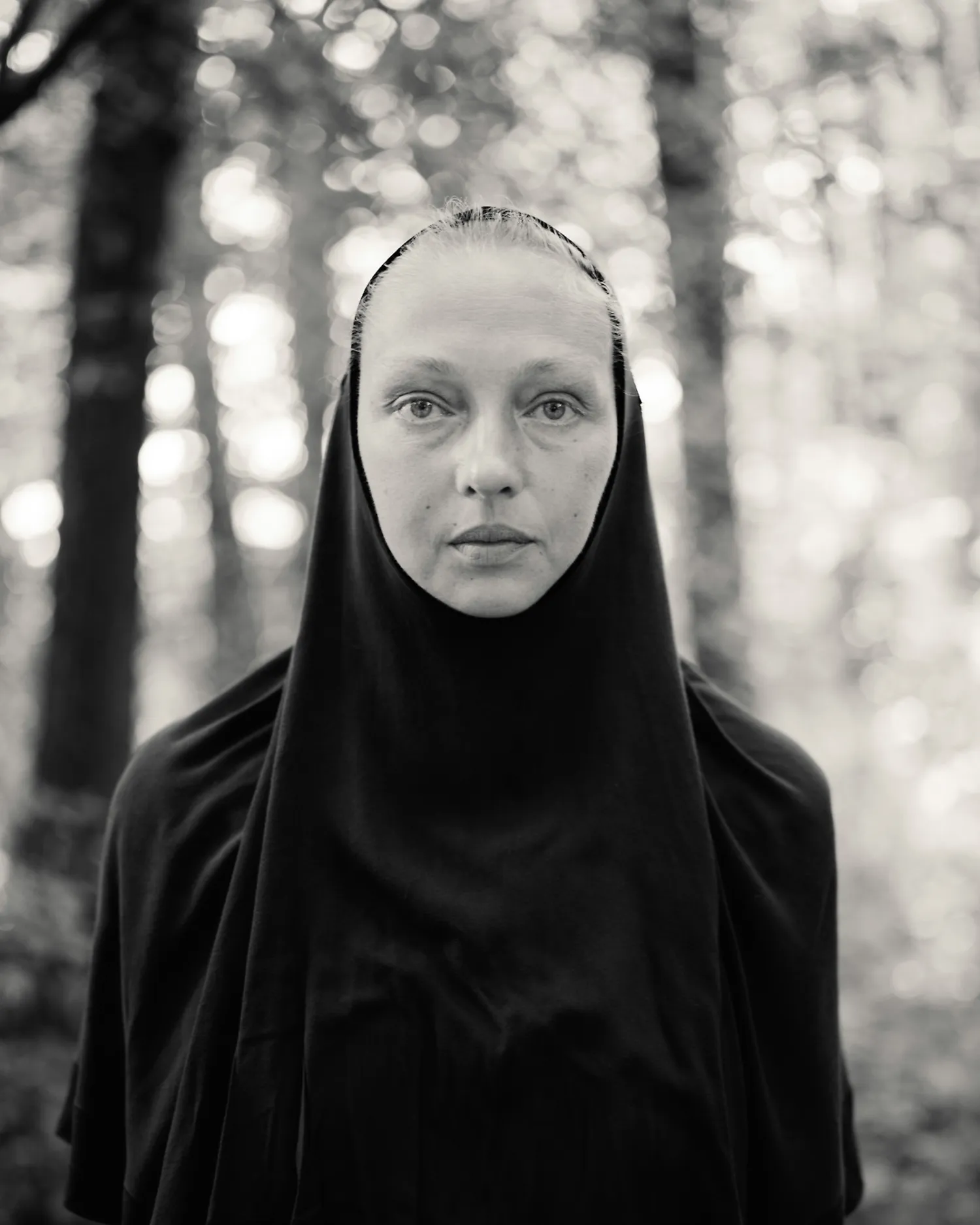 A black and white photograph of a nun