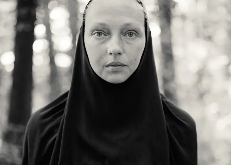 A black and white photograph of a nun